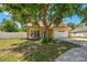 Inviting home features a cozy front porch, a two-car garage, and a lush front lawn at 24231 Satinwood Ct, Lutz, FL 33559