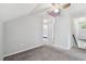 Upstairs hallway featuring carpeting, skylight, and a view of the staircase at 24231 Satinwood Ct, Lutz, FL 33559