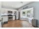 Bright kitchen features stainless steel appliances, granite countertops, and a charming bay window at 24231 Satinwood Ct, Lutz, FL 33559