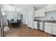 Open floor plan showing dining area adjacent to a kitchen with stainless steel appliances at 24231 Satinwood Ct, Lutz, FL 33559