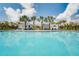 Community pool with clear blue water, palm trees, pergola, and lounge chairs at 2710 Bryce Ravine Ave, Plant City, FL 33563