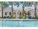 Close-up of community pool with accessible entry, pergola, palm trees, and outdoor seating at 2710 Bryce Ravine Ave, Plant City, FL 33563