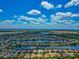 Aerial view of a suburban neighborhood with a lake and houses at 2875 Grazeland Dr, Sarasota, FL 34240