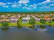 Aerial view of house with pool in the backyard overlooking a lake at 2875 Grazeland Dr, Sarasota, FL 34240