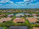 Aerial view of single Gathering house with front lawn and a lake at 2875 Grazeland Dr, Sarasota, FL 34240