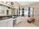 Elegant bathroom with dual sinks, granite countertops, soaking tub, and walk-in shower at 2875 Grazeland Dr, Sarasota, FL 34240
