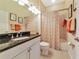 Cozy bathroom features a granite-topped vanity, and a shower with tiled walls at 2875 Grazeland Dr, Sarasota, FL 34240