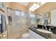 Bathroom with tiled walk-in shower, granite countertops and a large mirror at 2875 Grazeland Dr, Sarasota, FL 34240