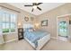 This bedroom features a ceiling fan and has a view of the outdoors at 2875 Grazeland Dr, Sarasota, FL 34240