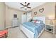 Comfortable bedroom features a queen-size bed, beach accents and a light ceiling fan at 2875 Grazeland Dr, Sarasota, FL 34240