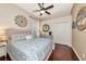 Comfortable bedroom featuring a queen-size bed, neutral walls and a light ceiling fan at 2875 Grazeland Dr, Sarasota, FL 34240