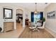 Bright dining room with a round table, a rug, modern lighting, and backyard views at 2875 Grazeland Dr, Sarasota, FL 34240