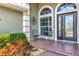Cozy front porch with seating area, perfect for relaxing and enjoying the neighborhood view at 2875 Grazeland Dr, Sarasota, FL 34240