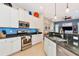 Modern kitchen with stainless steel appliances, white cabinetry, and granite countertops at 2875 Grazeland Dr, Sarasota, FL 34240
