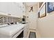 Laundry room with white cabinets, a washing machine, dryer and a sink at 2875 Grazeland Dr, Sarasota, FL 34240