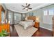 Serene main bedroom featuring hardwood floors, tray ceiling, and a tranquil view of the outdoors at 2875 Grazeland Dr, Sarasota, FL 34240