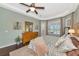 Inviting main bedroom with hardwood floors, tray ceiling, and access to outdoor pool area at 2875 Grazeland Dr, Sarasota, FL 34240