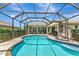 View of the pool and patio from the lawn of this backyard space at 2875 Grazeland Dr, Sarasota, FL 34240
