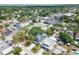 A high aerial view showcases the home's position in a neighborhood with lush trees and well-maintained residences on a sunny day at 3106 W Cherokee Ave, Tampa, FL 33611
