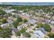 Expansive aerial view of a residential neighborhood with tree-lined streets and distant water views, capturing the community's charm at 3106 W Cherokee Ave, Tampa, FL 33611
