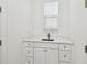 All-white bathroom with custom cabinets and drawers under sink at 3106 W Cherokee Ave, Tampa, FL 33611