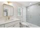 Updated bathroom features a glass shower, brushed gold finishes, and bright natural light at 3106 W Cherokee Ave, Tampa, FL 33611