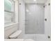 Updated bathroom features a glass shower, brushed gold finishes, and bright natural light at 3106 W Cherokee Ave, Tampa, FL 33611