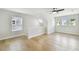 Spacious bedroom with wood floors, multiple windows, and ceiling fan at 3106 W Cherokee Ave, Tampa, FL 33611