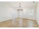 Dining room featuring hardwood floors, lots of light, neutral walls and designer lighting at 3106 W Cherokee Ave, Tampa, FL 33611