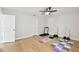 Exercise room featuring hardwood floors, a ceiling fan, and two entry doors at 3106 W Cherokee Ave, Tampa, FL 33611
