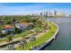Luxury homes and palm trees line a waterfront street with a picturesque skyline backdrop, showcasing an upscale coastal lifestyle at 3106 W Cherokee Ave, Tampa, FL 33611