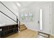 Foyer featuring natural light, hardwood flooring, modern trim, and entry to staircase at 3106 W Cherokee Ave, Tampa, FL 33611