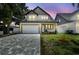 Charming two-story home with a well-manicured lawn and paver driveway at 3106 W Cherokee Ave, Tampa, FL 33611