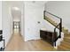 Hallway showcasing natural light, hardwood flooring, modern trim, and entry to staircase at 3106 W Cherokee Ave, Tampa, FL 33611
