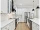 Modern kitchen with white cabinets, stainless steel appliances, and sleek countertops at 3106 W Cherokee Ave, Tampa, FL 33611