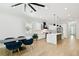 Stylish open-concept kitchen and dining area with sleek white cabinets and modern decor at 3106 W Cherokee Ave, Tampa, FL 33611