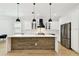 Bright kitchen featuring a wood accent island, stainless appliances, and modern pendant lighting at 3106 W Cherokee Ave, Tampa, FL 33611