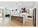 Bright kitchen featuring a wood accent island, stainless appliances, and modern pendant lighting at 3106 W Cherokee Ave, Tampa, FL 33611