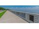 Scenic waterfront with a sidewalk alongside a retaining wall, offering pedestrian access and views of the bay and skyline at 3106 W Cherokee Ave, Tampa, FL 33611
