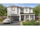 Charming two-story home featuring a two-car garage, inviting front porch, and manicured lawn at 3303 W Tambay Ave, Tampa, FL 33611