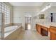 Clean bathroom with tile flooring, a tub, and double vanity sinks at 3510 Hickory Hammock Loop, Wesley Chapel, FL 33544