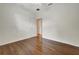 Bedroom with hardwood floors with door to hallway and closet at 3510 Hickory Hammock Loop, Wesley Chapel, FL 33544
