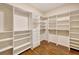 Spacious walk-in closet with custom shelving and drawers, providing ample storage space and organization at 3510 Hickory Hammock Loop, Wesley Chapel, FL 33544