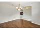 Elegant dining room with dark wood floors and a charming chandelier at 3510 Hickory Hammock Loop, Wesley Chapel, FL 33544