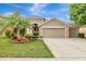 Charming tan home with well-manicured front yard, featuring a two-car garage and inviting curb appeal at 3510 Hickory Hammock Loop, Wesley Chapel, FL 33544