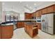 Spacious kitchen with dark wood cabinets, stainless steel appliances, and granite countertops at 3510 Hickory Hammock Loop, Wesley Chapel, FL 33544