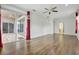 Open living room with red drapes and a sliding door to the outside patio at 3510 Hickory Hammock Loop, Wesley Chapel, FL 33544