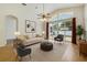 Bright living room with a ceiling fan, comfortable seating, and sliding doors to the outdoors at 3510 Hickory Hammock Loop, Wesley Chapel, FL 33544