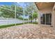 Screened-in patio featuring brick pavers, a ceiling fan, and sliding doors leading to the interior at 3510 Hickory Hammock Loop, Wesley Chapel, FL 33544