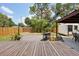 Backyard deck features a barbeque grill, mature plantings, and a fenced perimeter, making for a private retreat at 511 Glenoak N St, St Petersburg, FL 33703